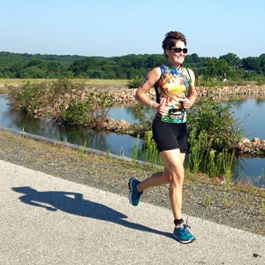 photo of Mary Braun cruising around the reservoir in the 2015 Top of Delaware Sprint Triathlon
