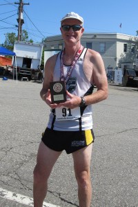 photo of Mark Deshon with age-group winning plaque