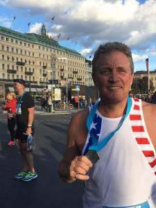 photo of Tripp Shenton with medal in Stockholm